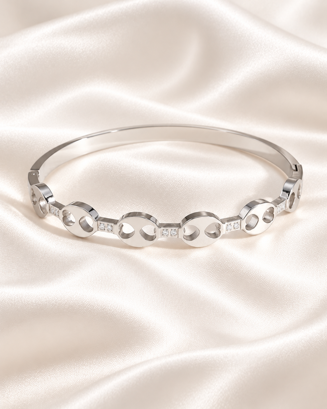 Bangle bracelet with oval motifs and cubic zirconia